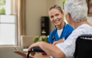 Friendly nurse talking to senior patient about bowel care